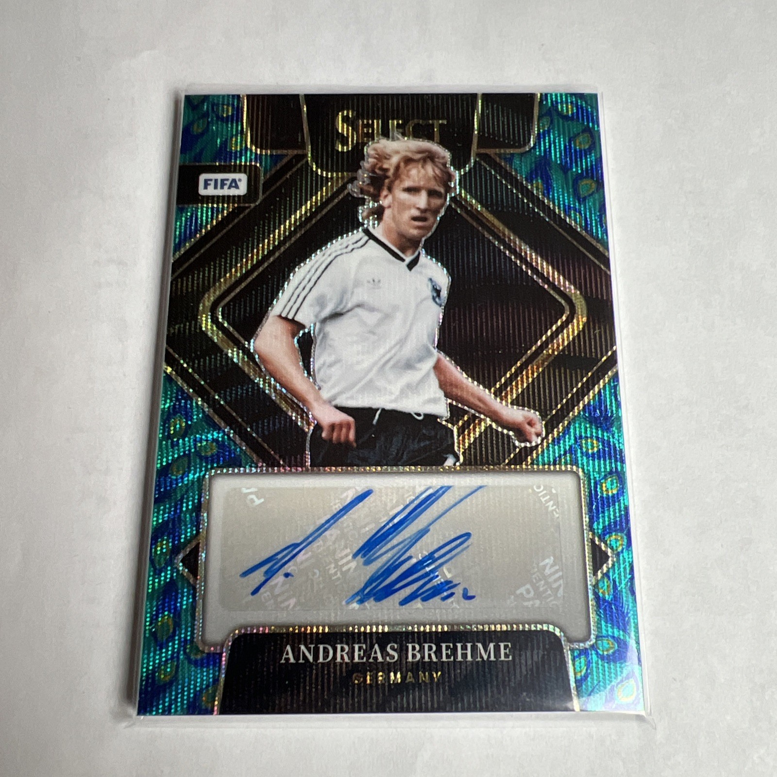 2022-23 Panini Select FIFA – Signatures Andreas Brehme #S-AB Peacock Prizm (AU)