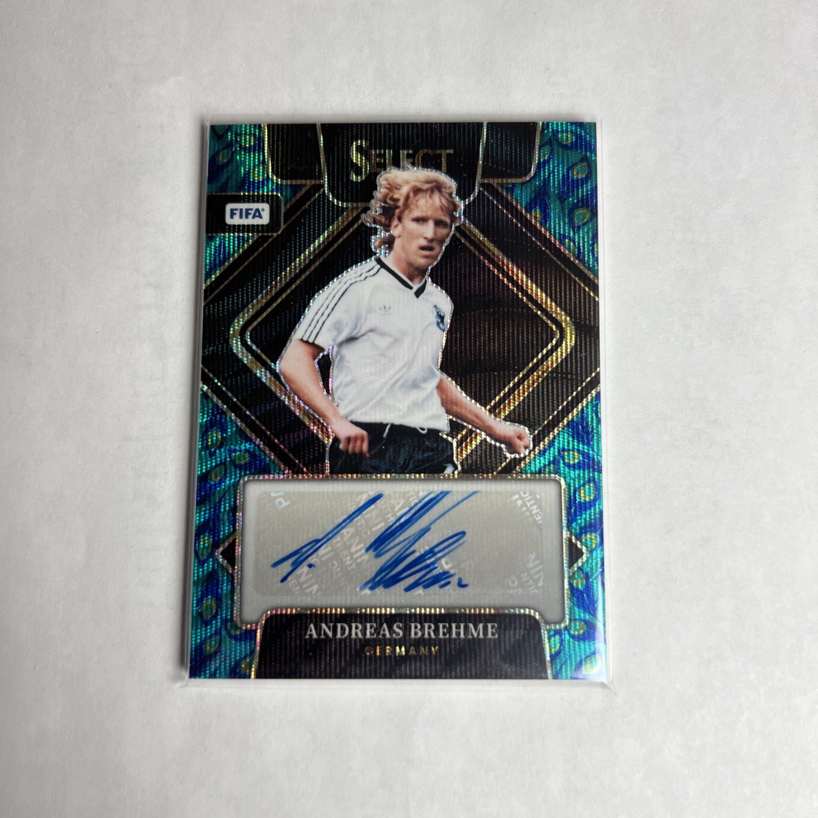 2022-23 Panini Select FIFA – Signatures Andreas Brehme #S-AB Peacock Prizm (AU)